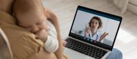 woman at laptop with infant